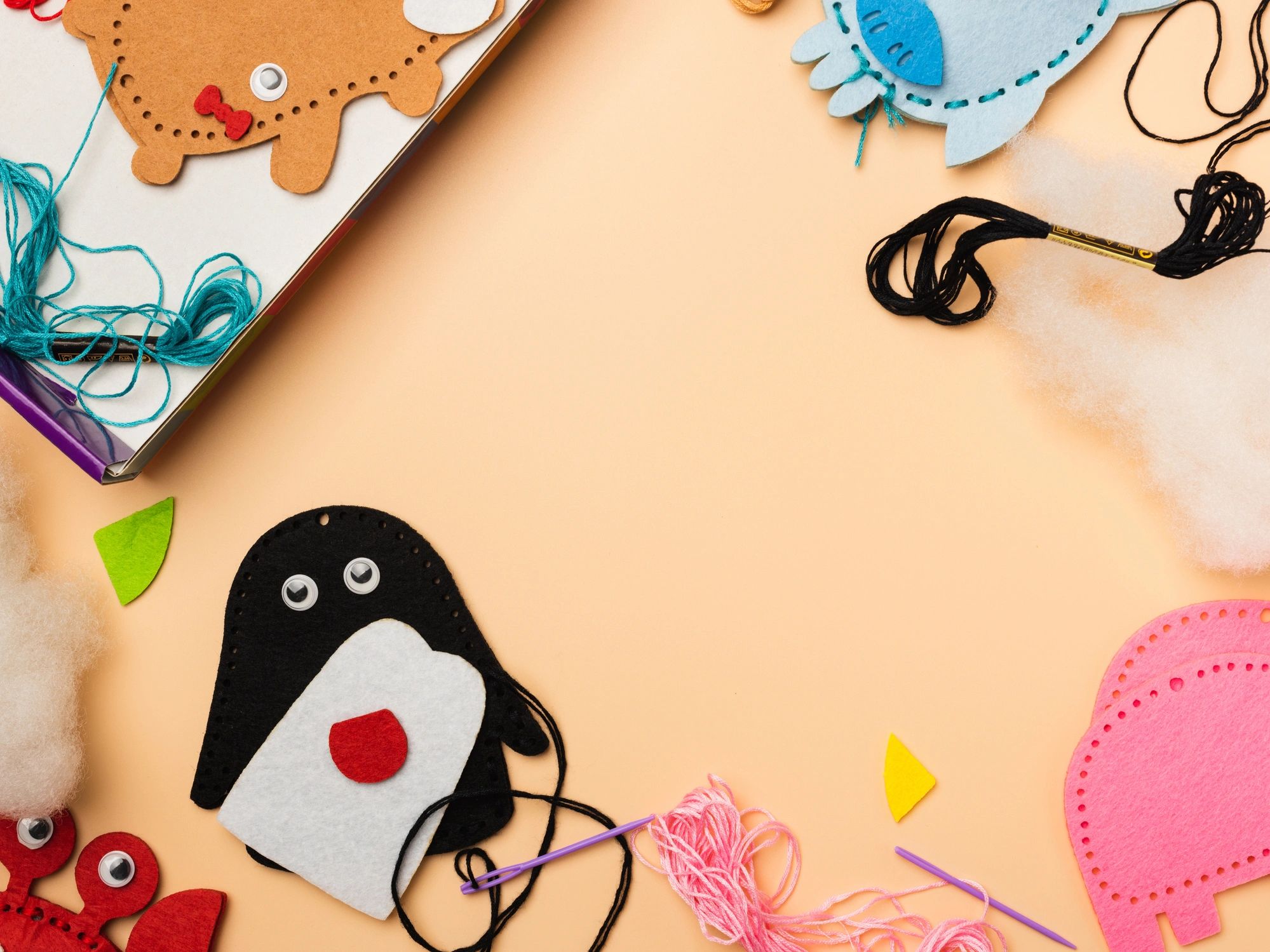Colorful sewing materials arranged neatly on a pastel background